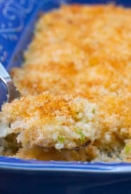 spoonful of Twice Baked Potato Casserole over the dish, showing its texture