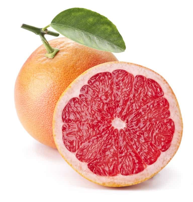 half of grapefruit, with whole grapefruit behind