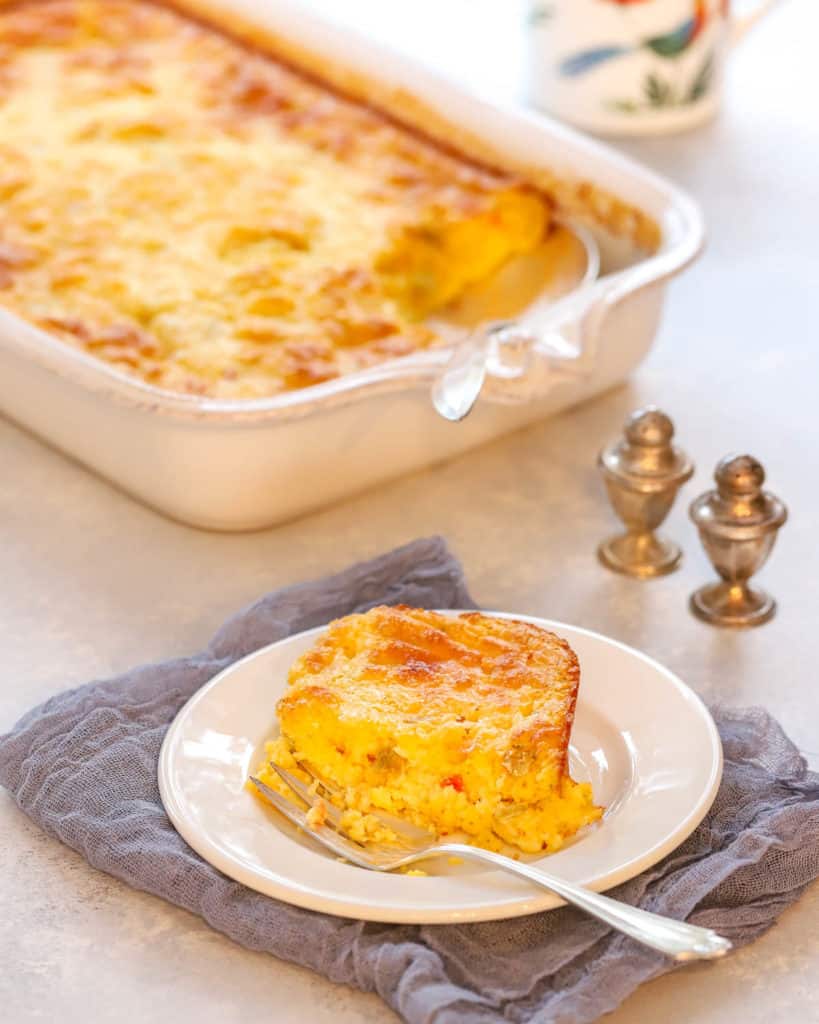 plate holding a single serving of breakfast casserole, with rest in background