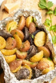 Foil packet filled with grilled new potatoes, seasoned with Parmesan Cheese, parsley and truffle zest.