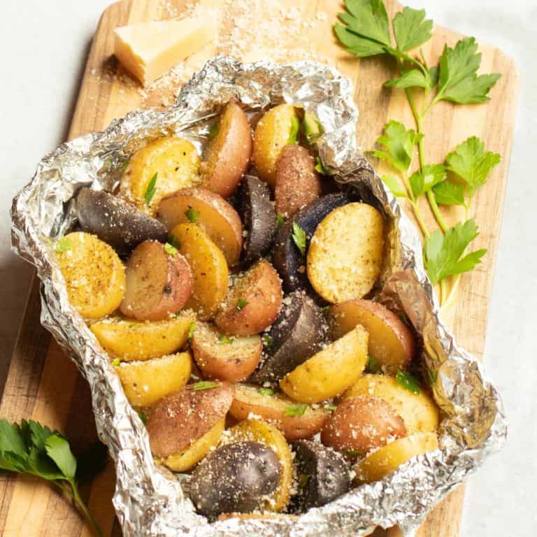 Foil packet filled with grilled new potatoes, seasoned with Parmesan Cheese, parsley and truffle zest.
