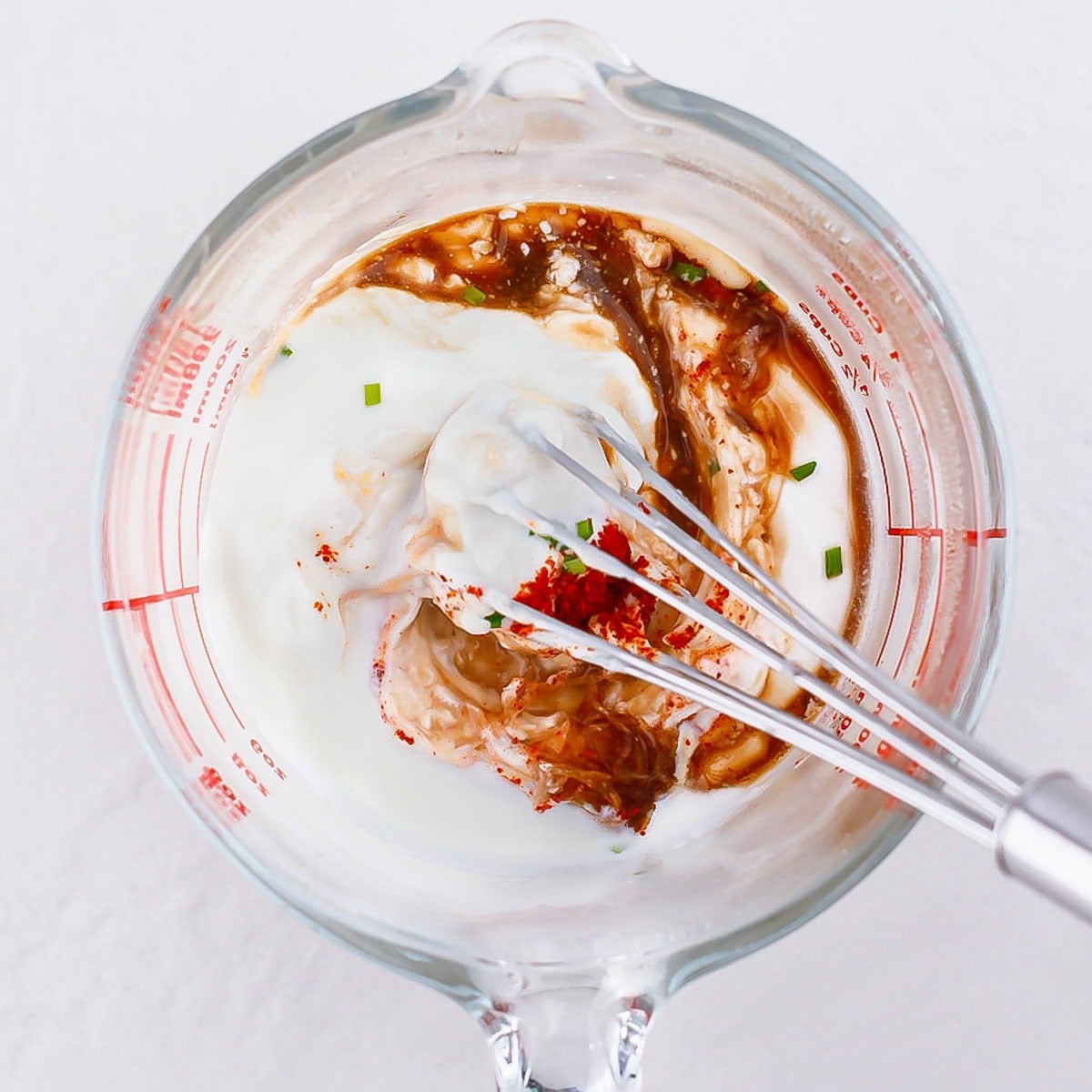 Mixing the creamy horseradish dressing in a dish.