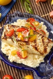 Fish shaped blue platter with Halibut with Celery Root Purée and Tomato Garnish.
