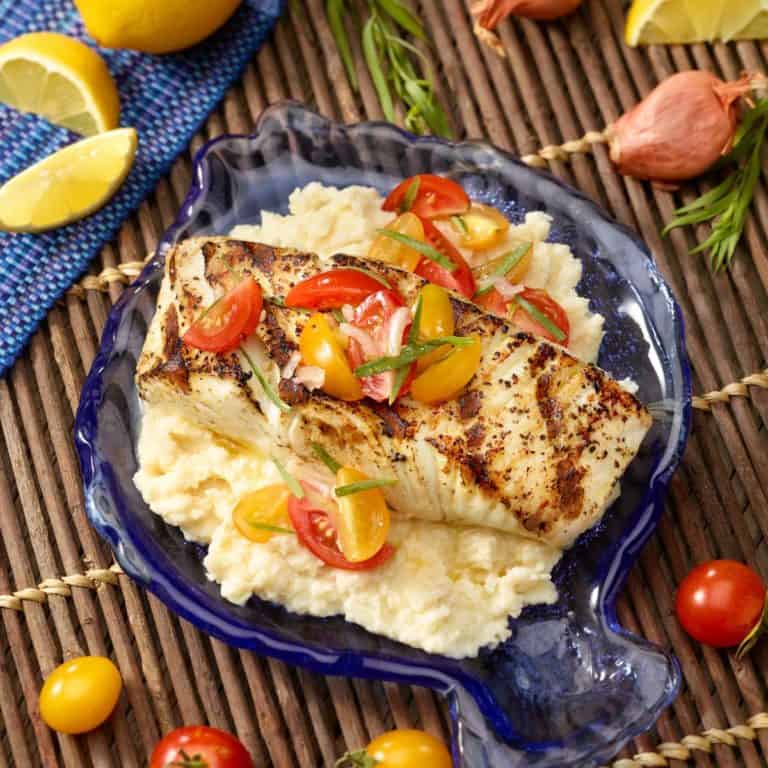 Fish shaped blue platter with Halibut with Celery Root Purée and Tomato Garnish.