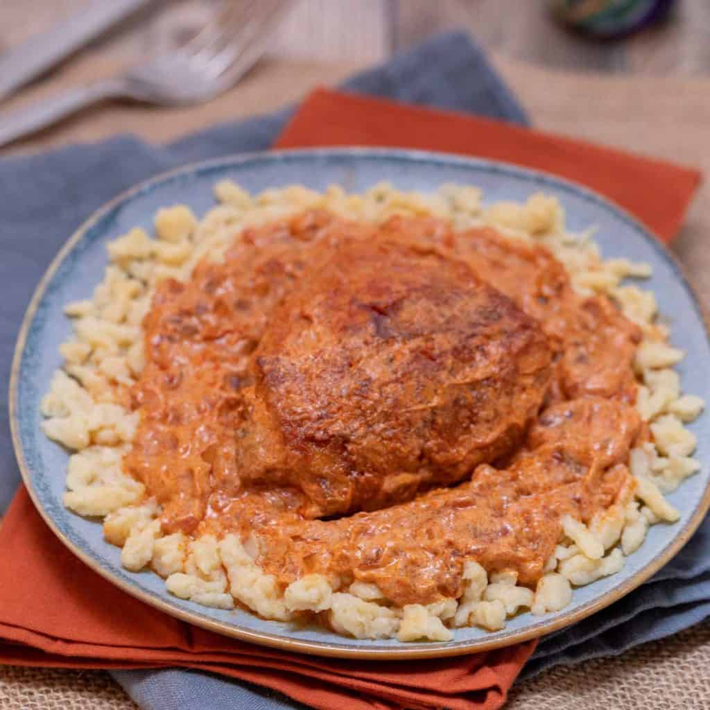 Close up of blue plate holding a portion of Chicken Paprikash