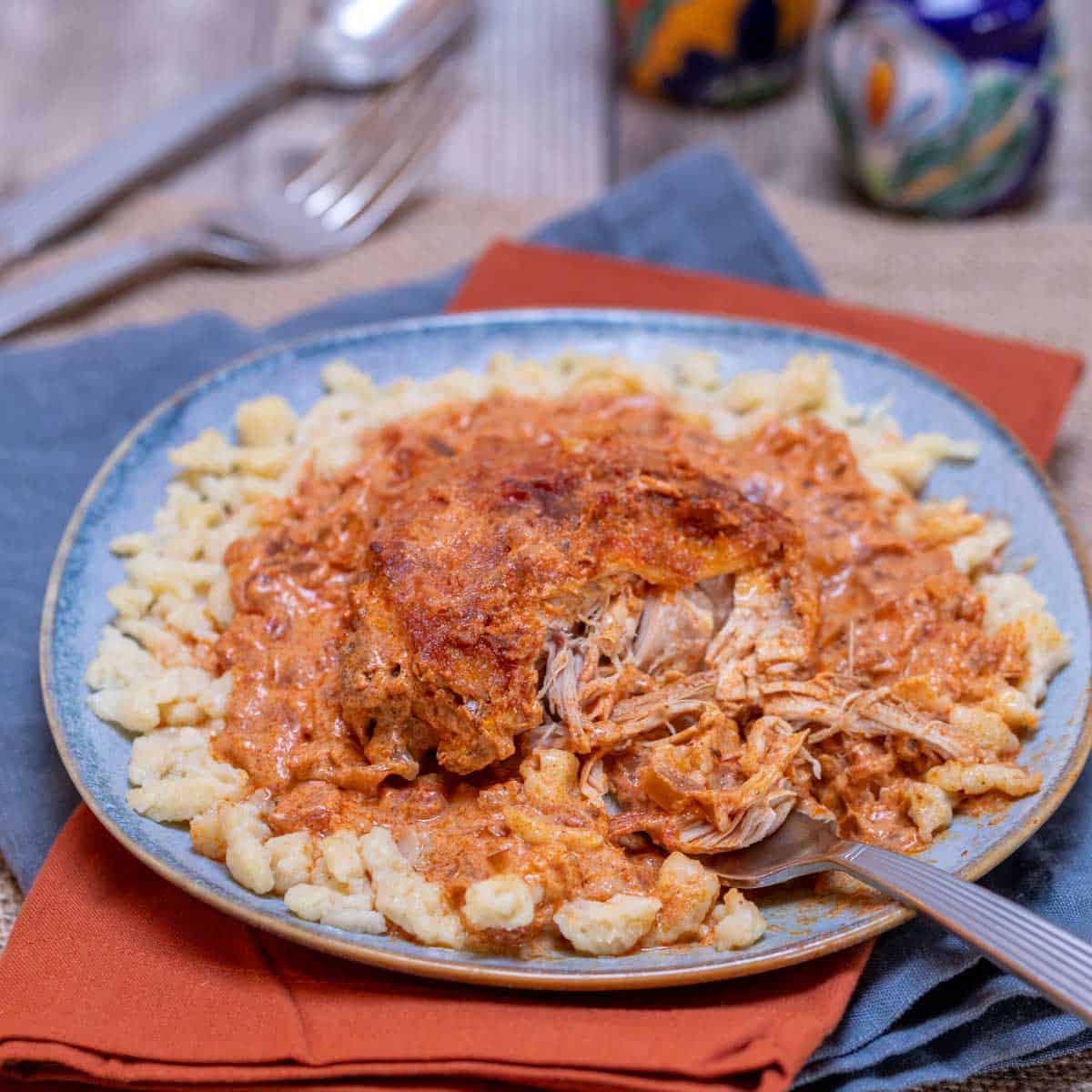 blue plate showing a portion of Hungarian Chicken Paprikash