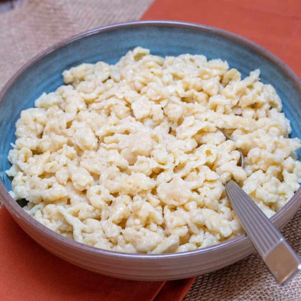 blue bowl and spoon showing Nokedli, or Hungarian Dumplings