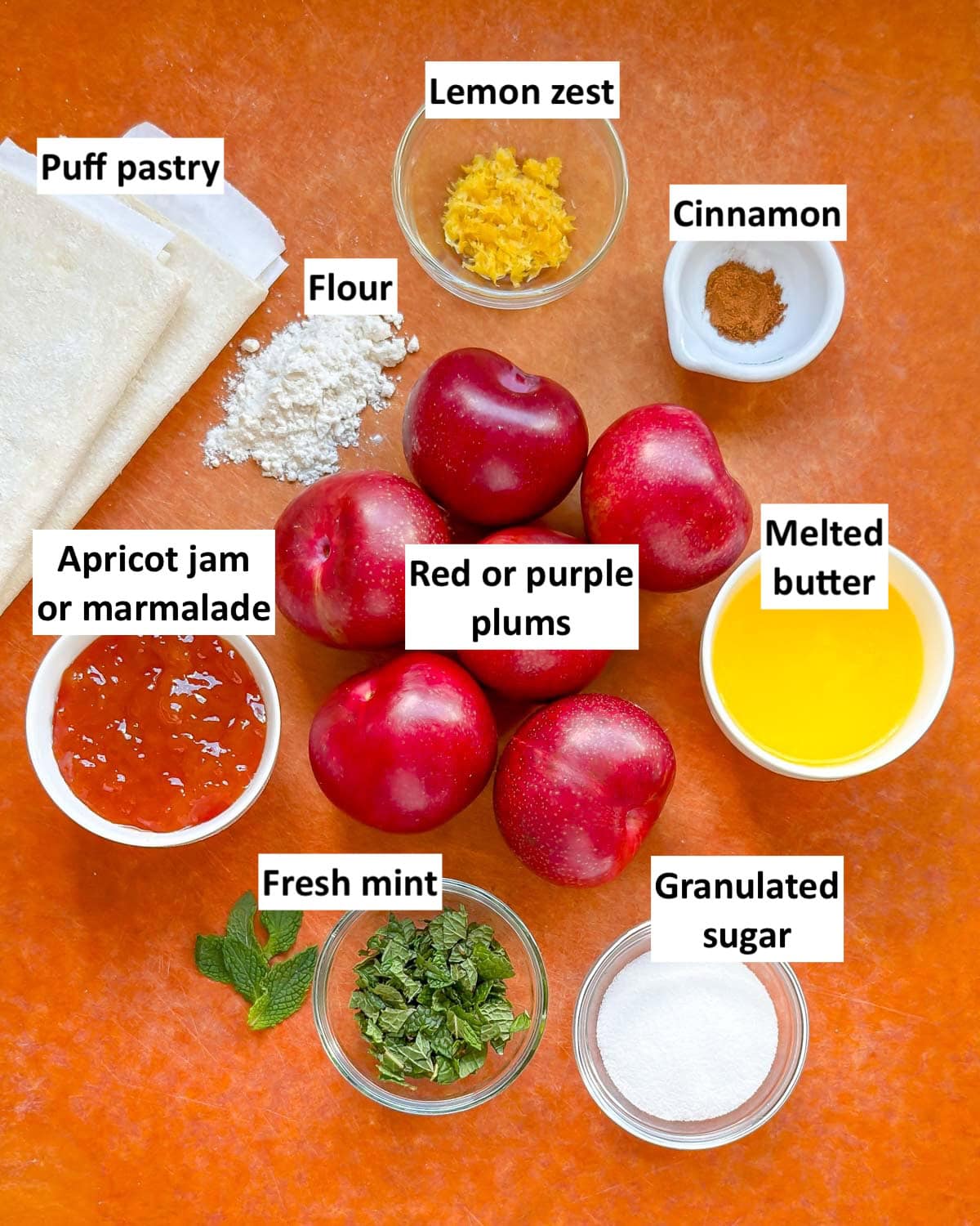 Ingredients to make homemade plum tarts on a countertop. 