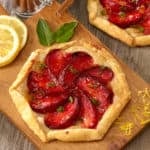 Single portion of a plum tart on a cutting board.