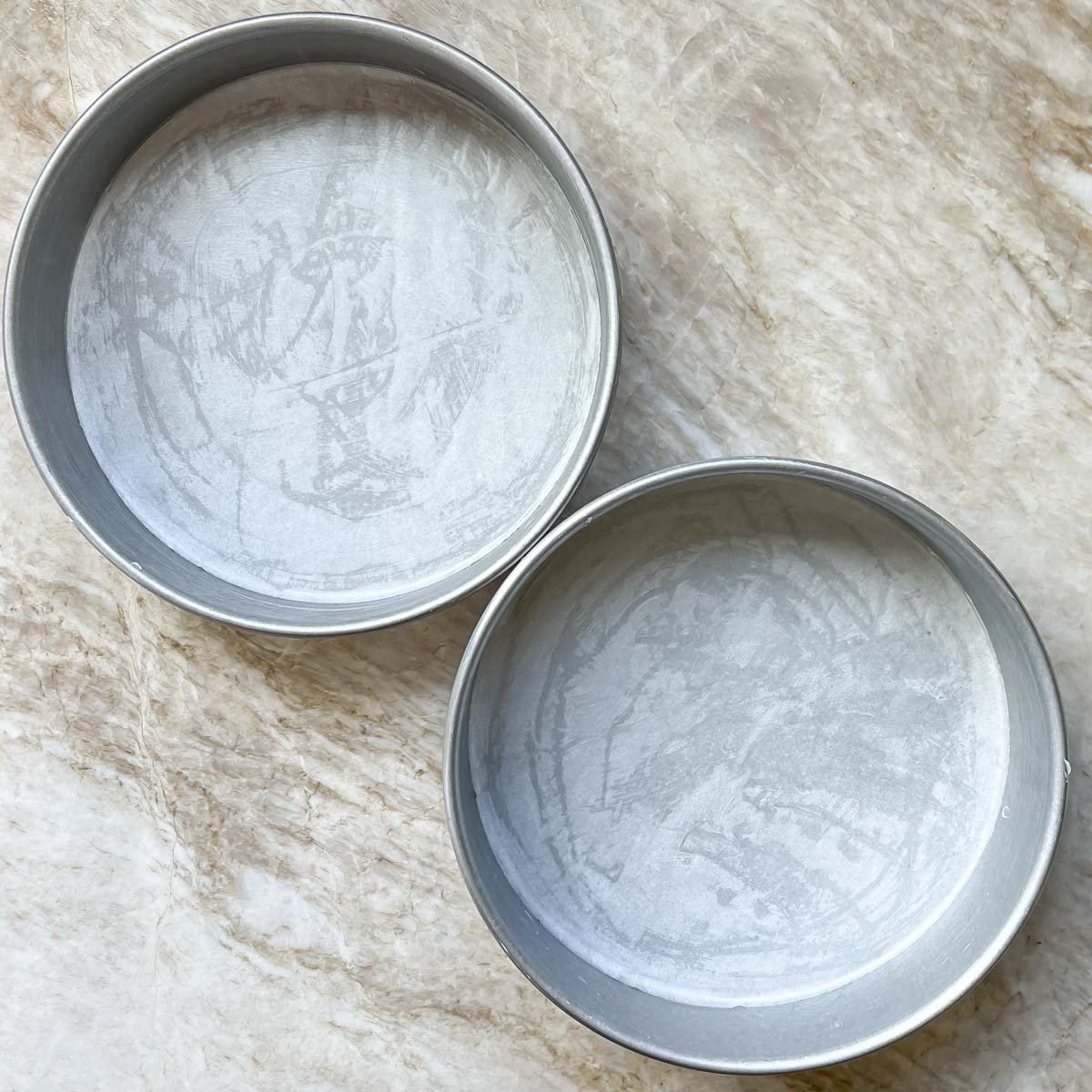 two cake pans buttered and lined with parchment paper