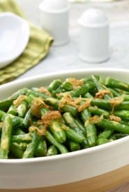 Oval white dish filled with Lemon-Dijon Green Beans with Caramelized Shallots