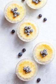 Overhead view of small glass dishes filled with baked Lemon Pudding Cups