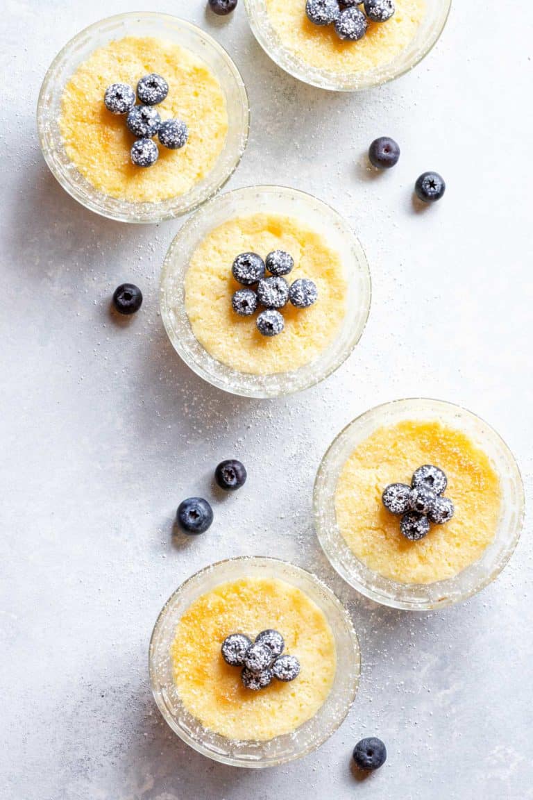 Overhead view of small glass dishes filled with baked Lemon Pudding Cups