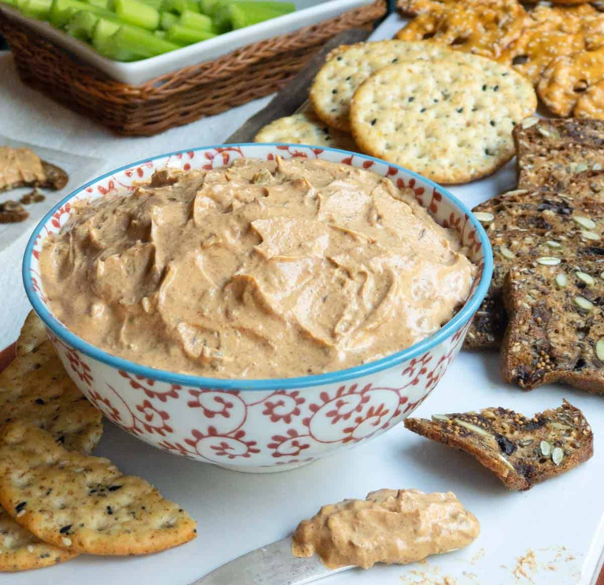 Red and white bowl filled with Liptauer Cheese Spread