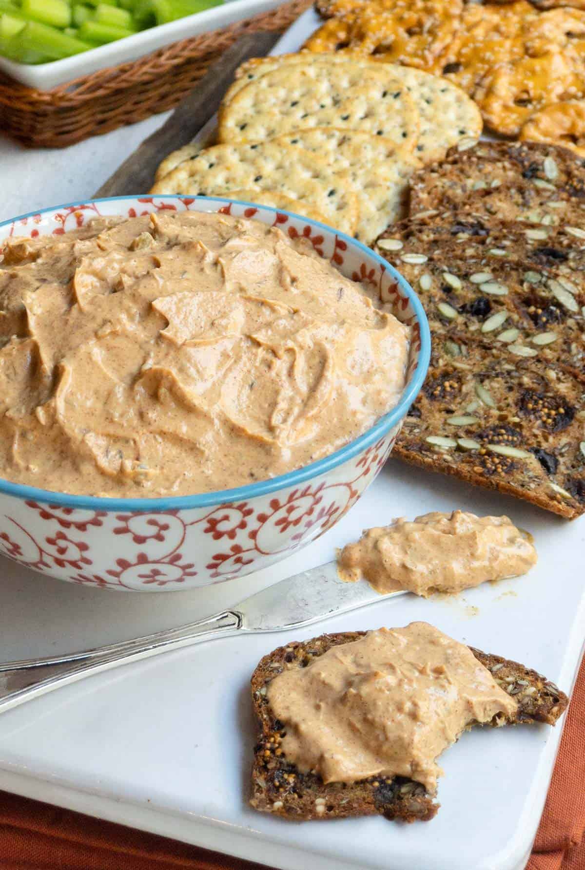 Red and white patterened bowl filled with Liptauer Cheese Spread