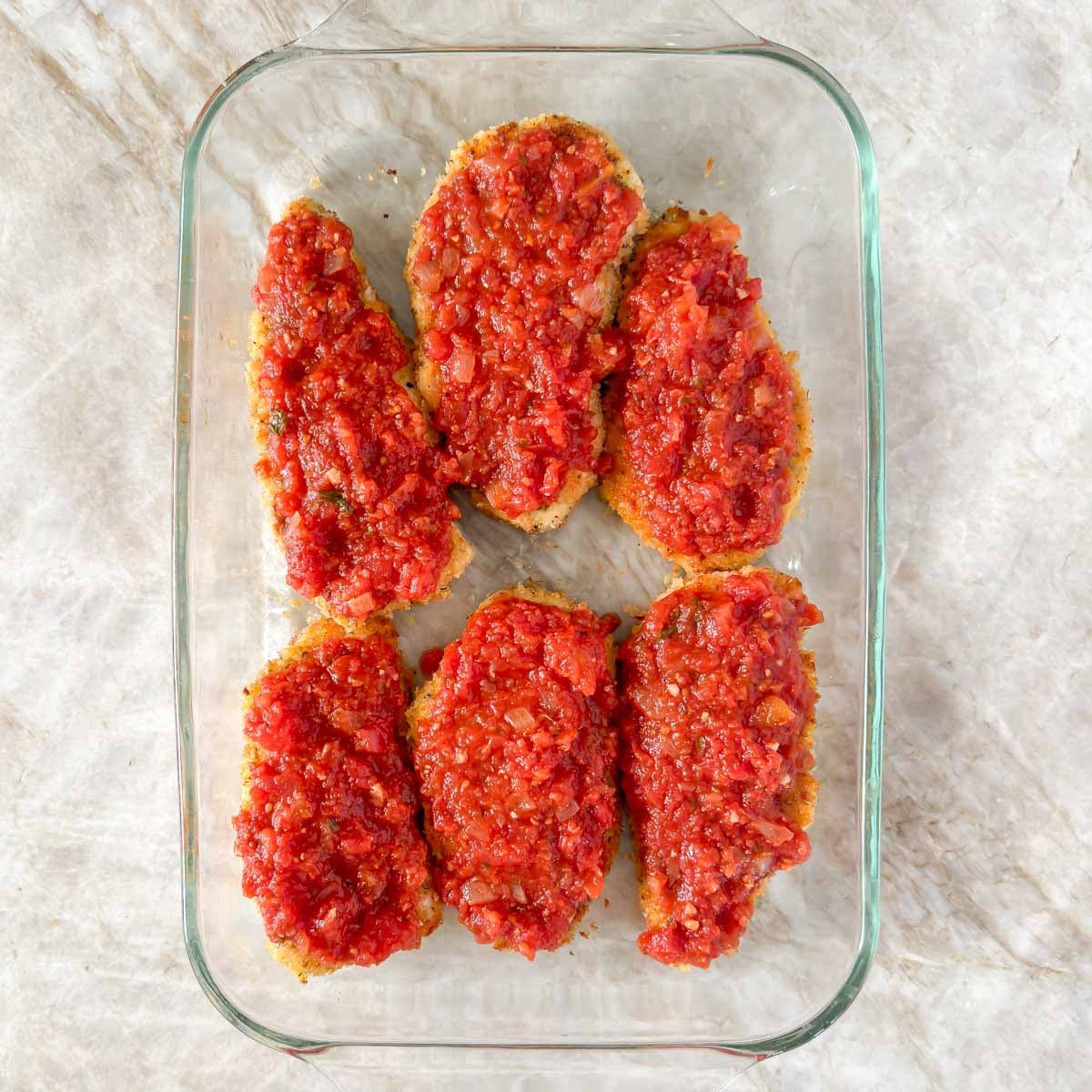 6 breaded and pan seared chicken breasts topped with marinara sauce.