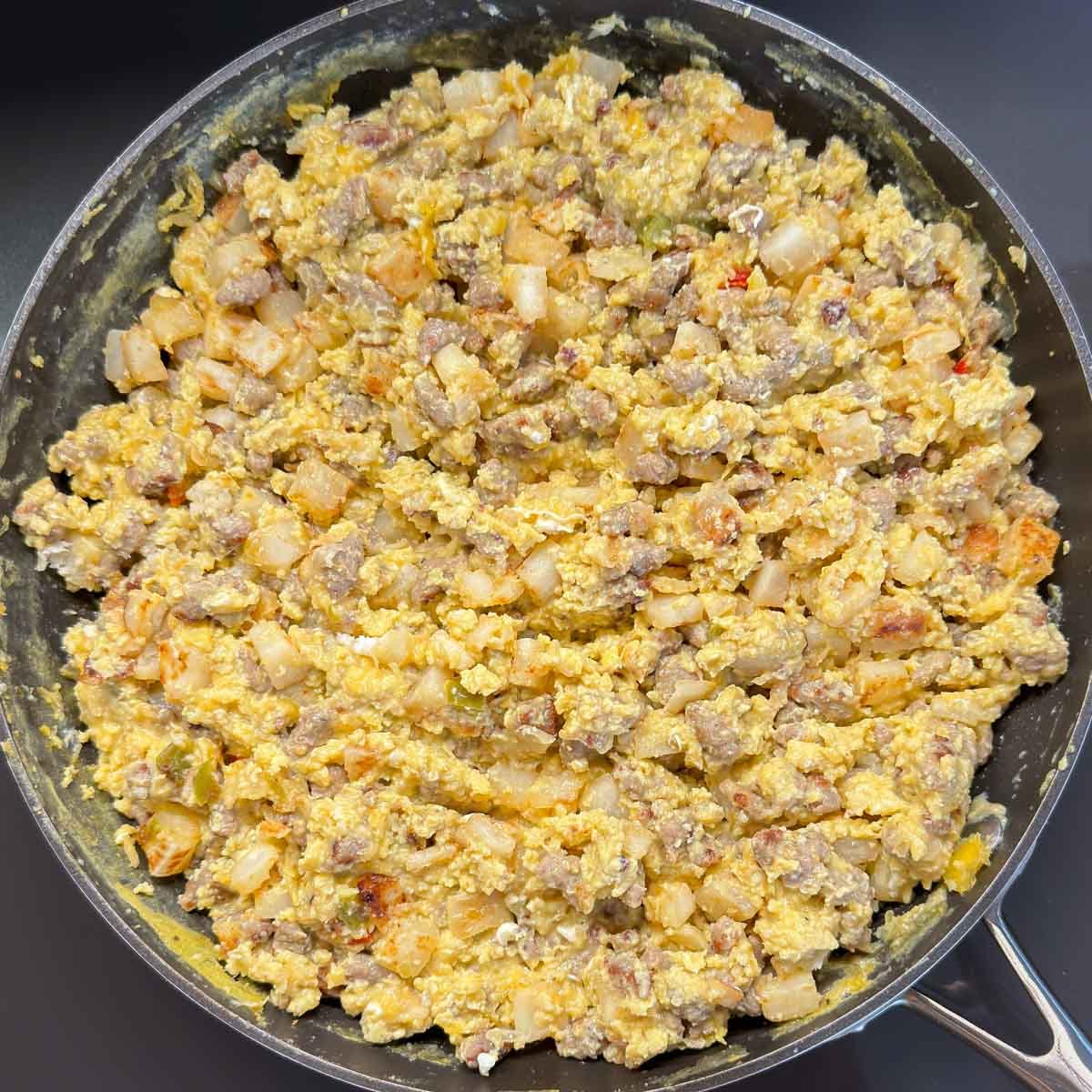 Cooked burrito filling inside a large skillet.