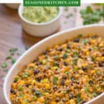 Oval white baking dish filled with Mexican Chicken Black Beans and Rice