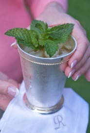 Mint julep cup holding a single serving with a white napkin underneath