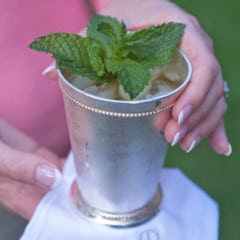 Mint julep cup holding a single serving with a white napkin underneath