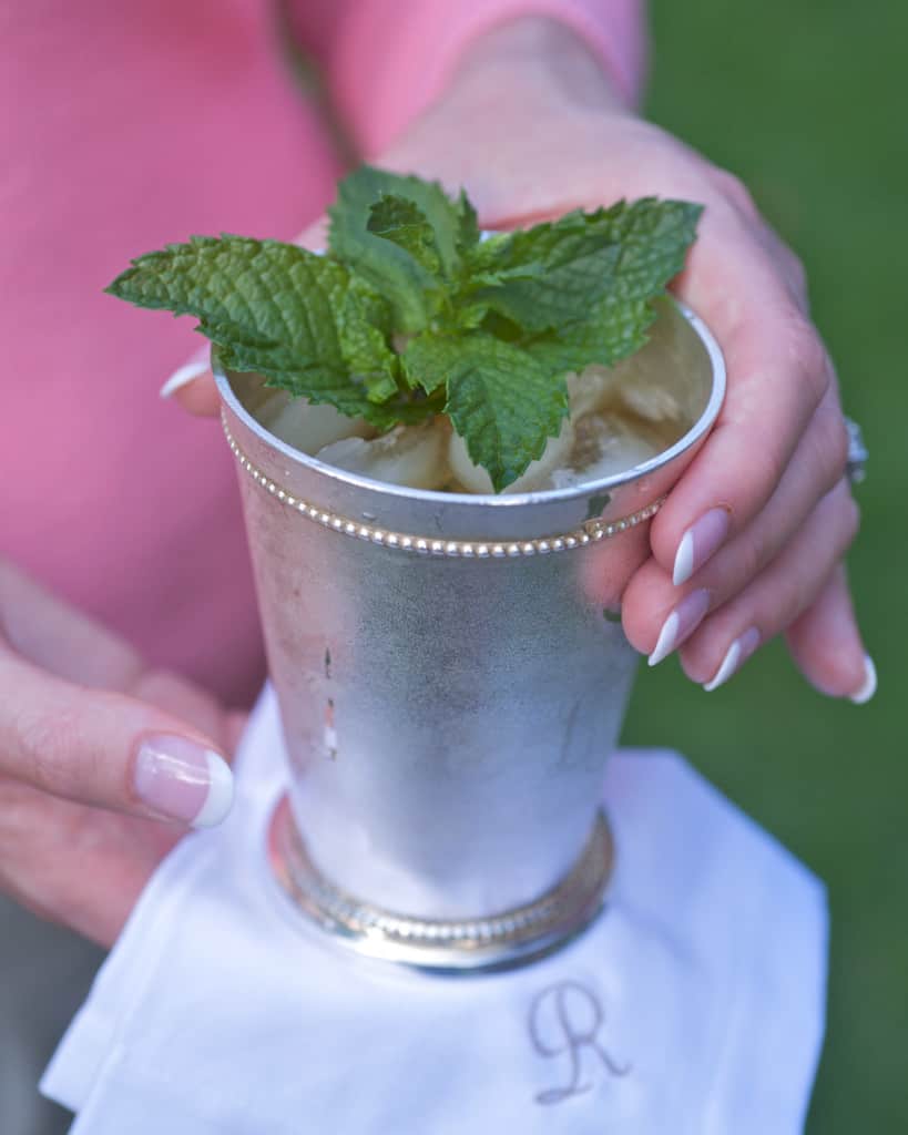 Mint julep cup holding a single serving with a white napkin underneath