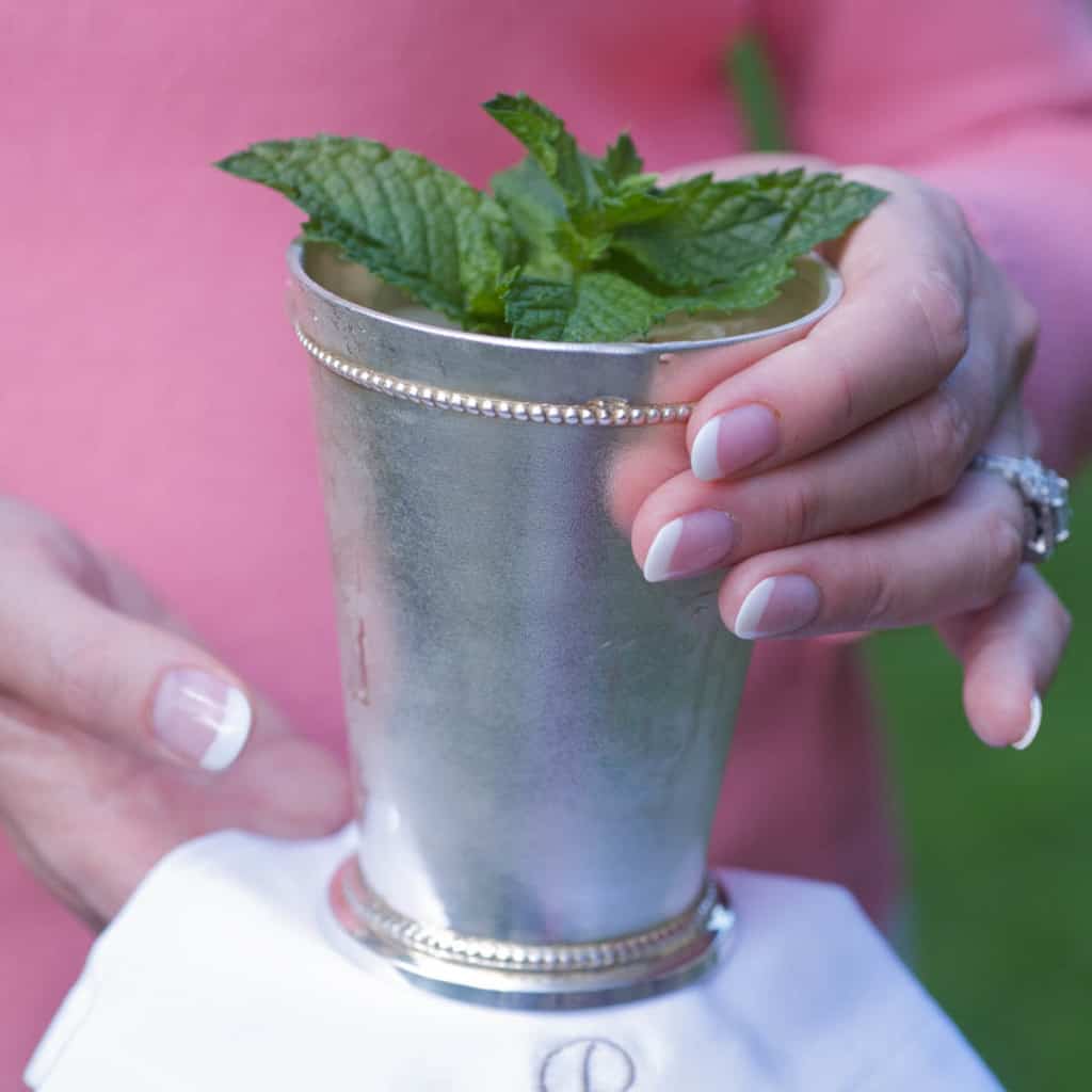 Mint julep cup holding a single serving with a white napkin underneath