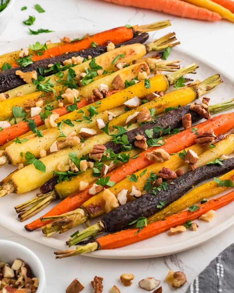 Oven roasted carrots on a white platter.