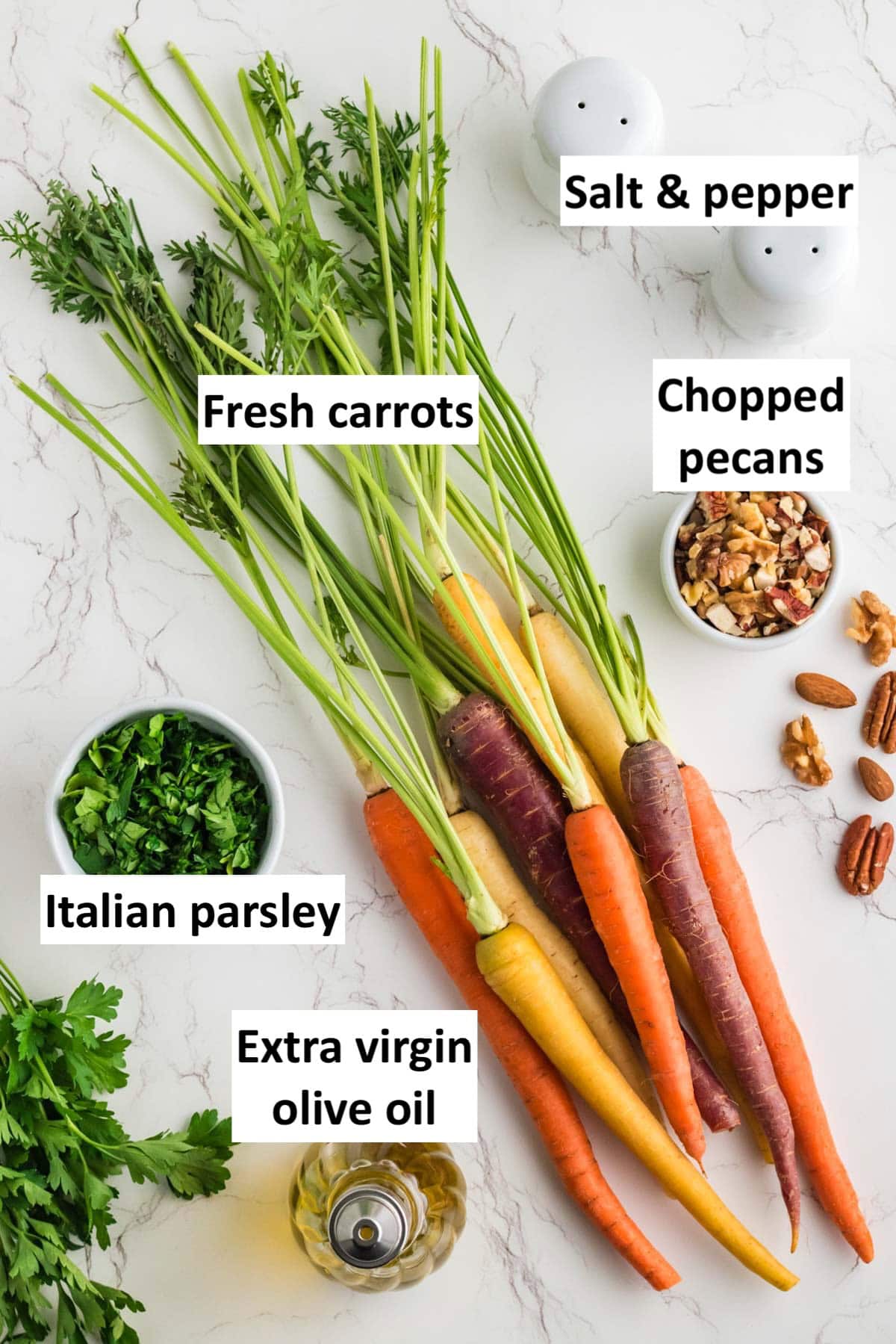 Ingredients to make roasted carrots in oven on a countertop with text labels.