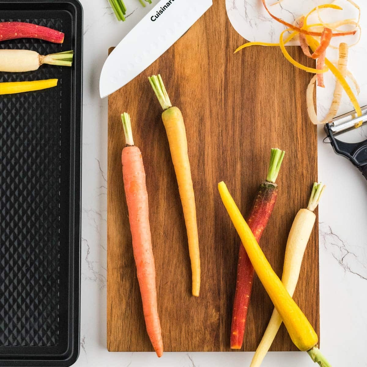 Preparing colored carrots to roast in the oven.
