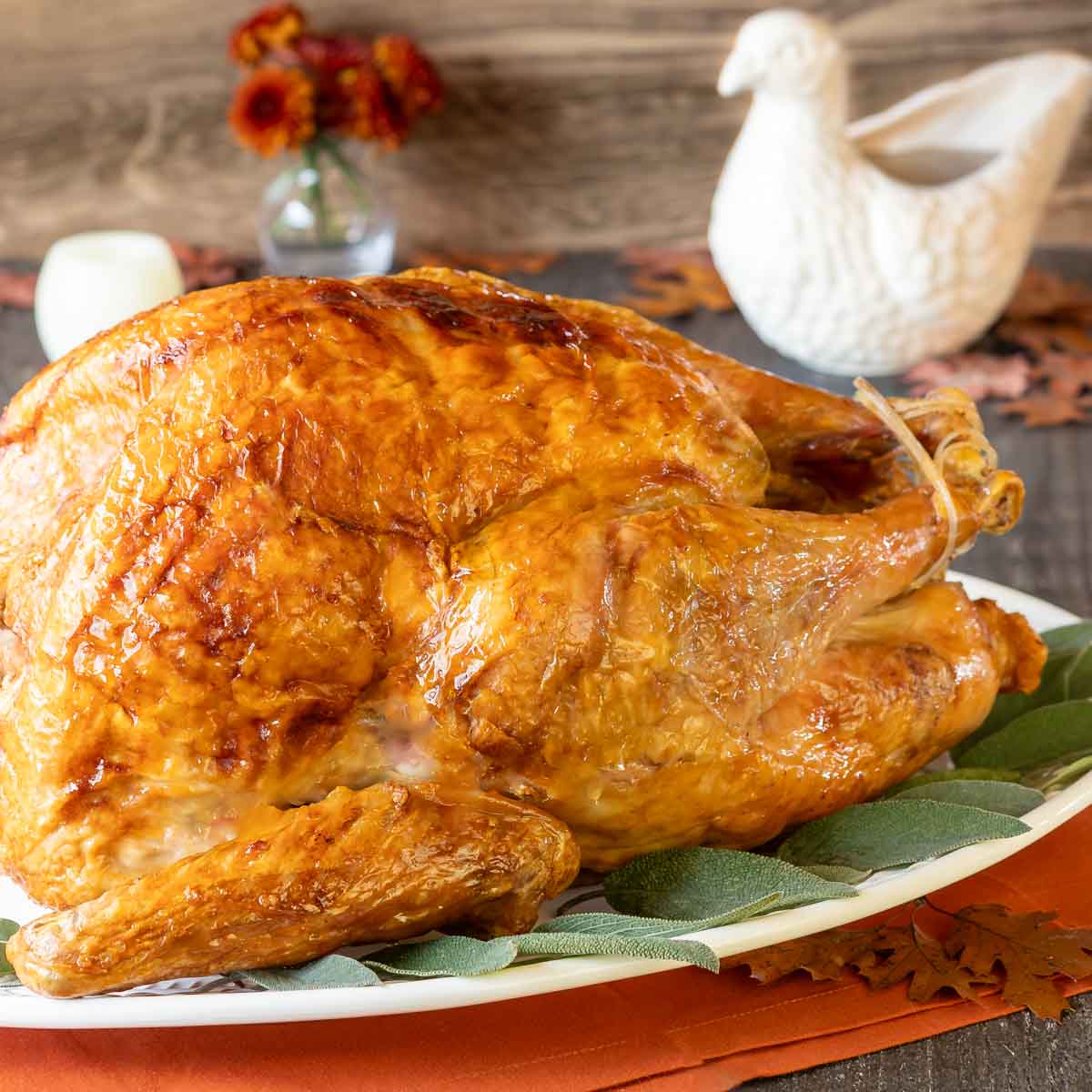 Golden roasted turkey with meat thermometer on table Stock Photo