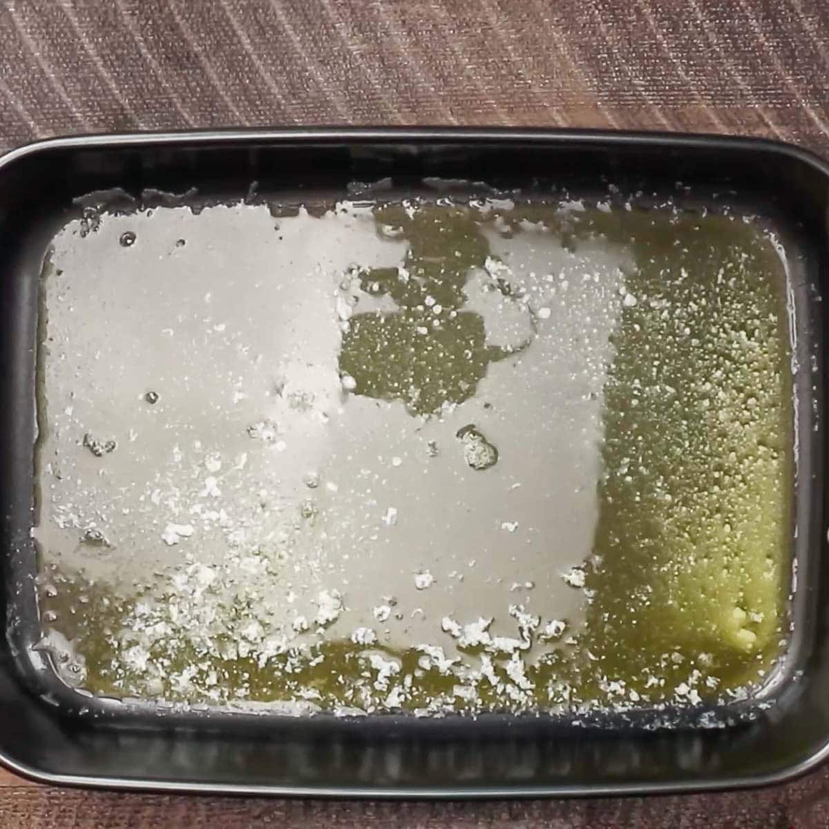 Melted butter in the baking pan. 
