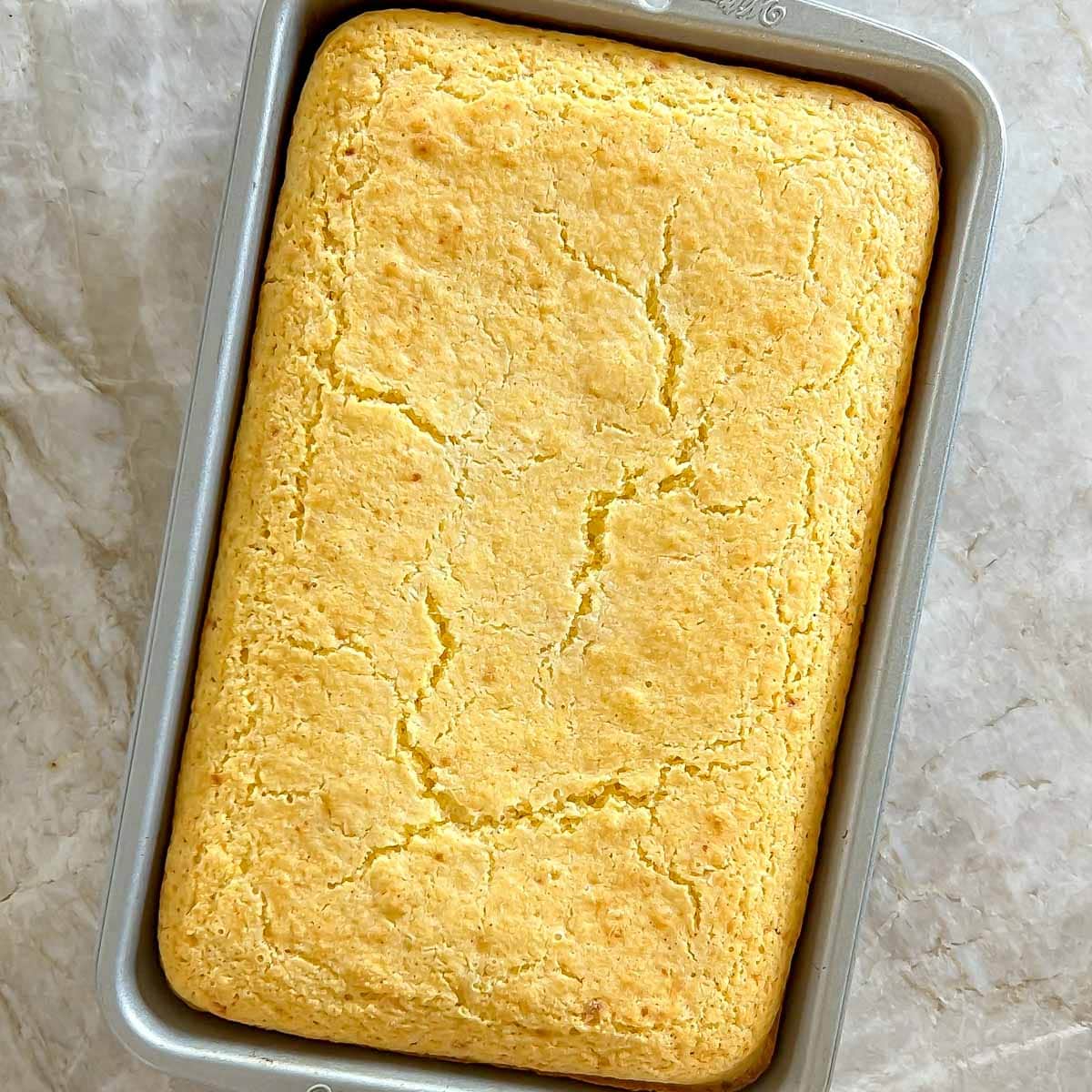 overhead of baked Parmesan Buttermilk Cornbread in baking dish