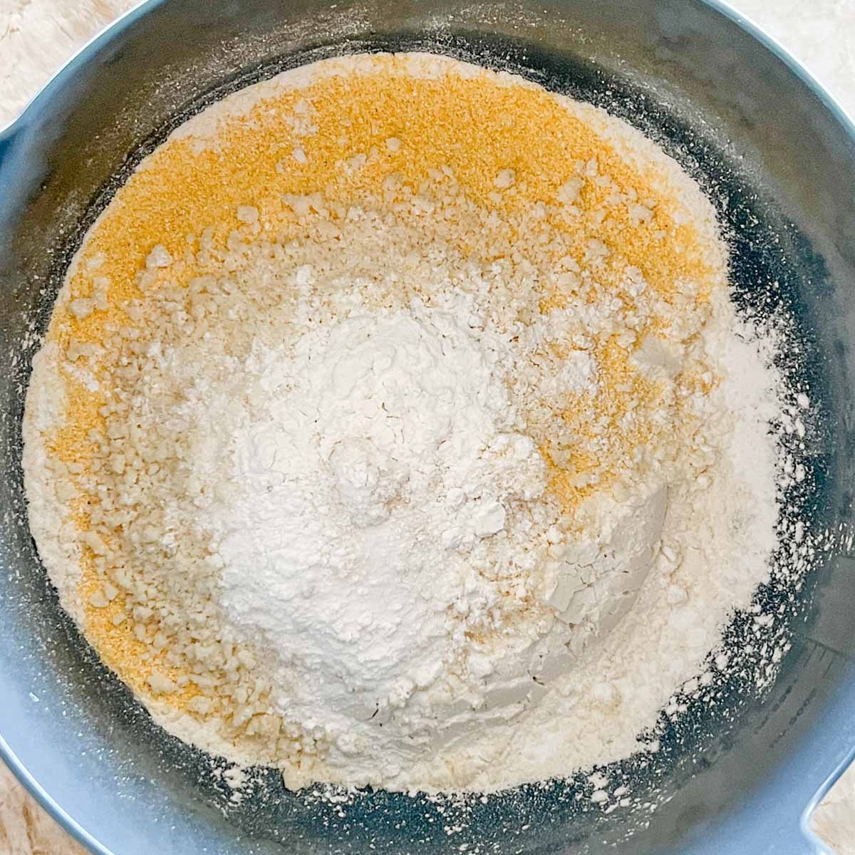 overhead of all the dry ingredients for Parmesan Buttermilk Cornbread in a bowl