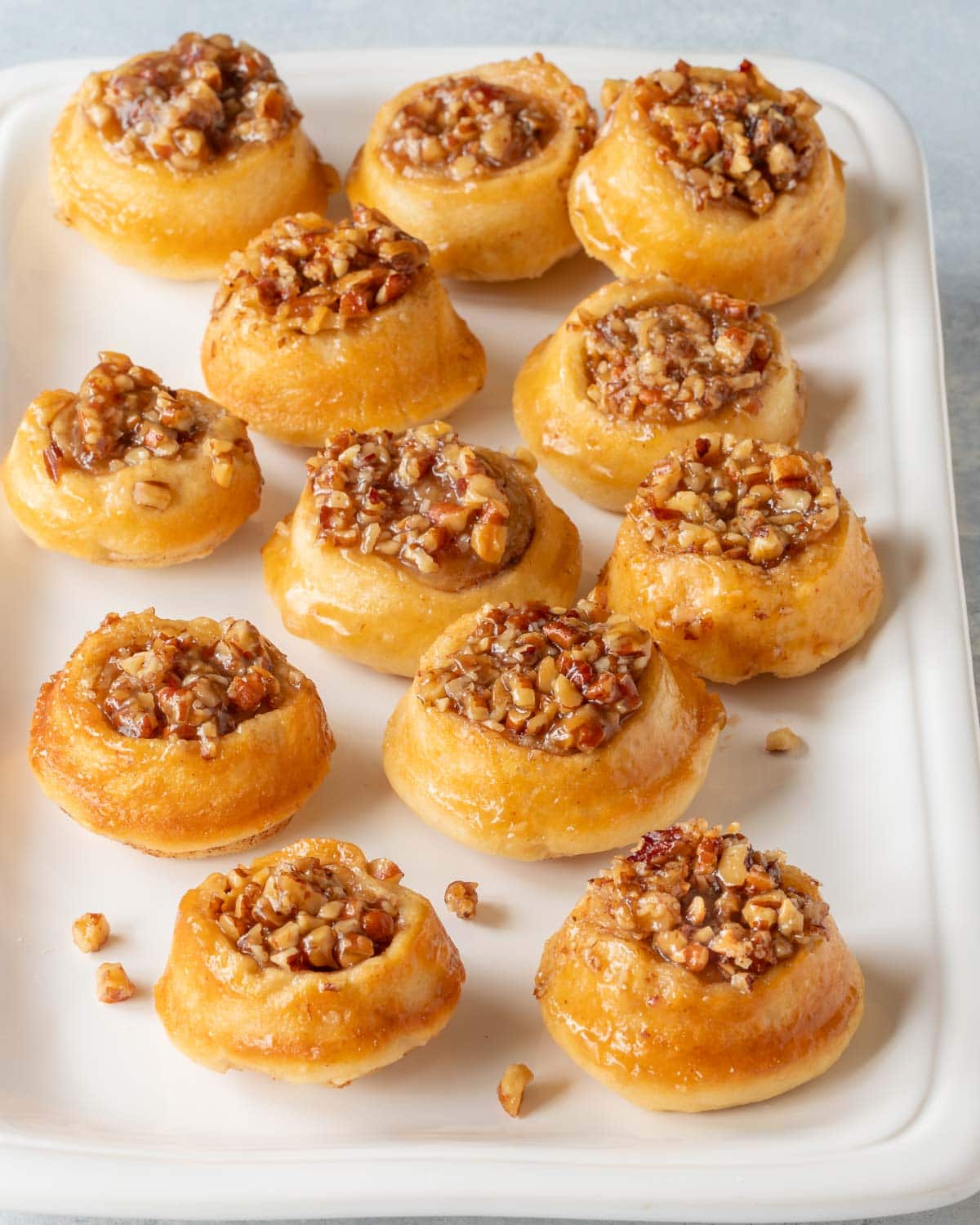 white platter holding around 1 dozen mini pecan rolls