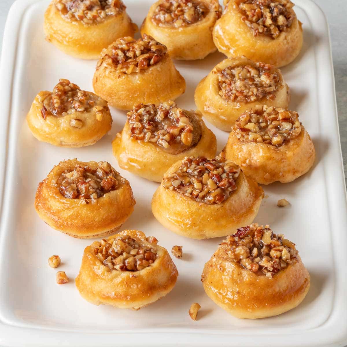 white platter holding around 1 dozen mini pecan rolls