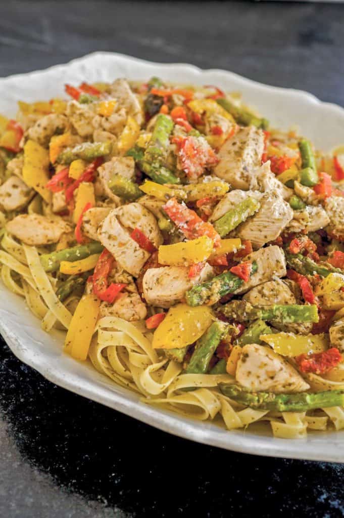 White platter showing Pesto Chicken and Vegetables with Pasta