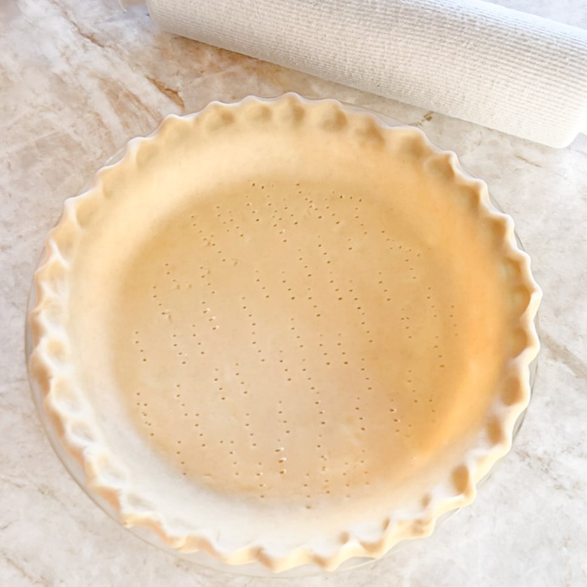 Unbaked pie crust dough in a pie pan