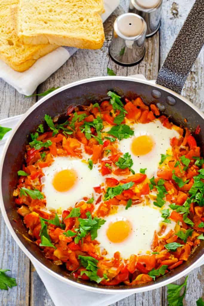 Skillet filled with Poached Eggs in Italian Tomato Sauce
