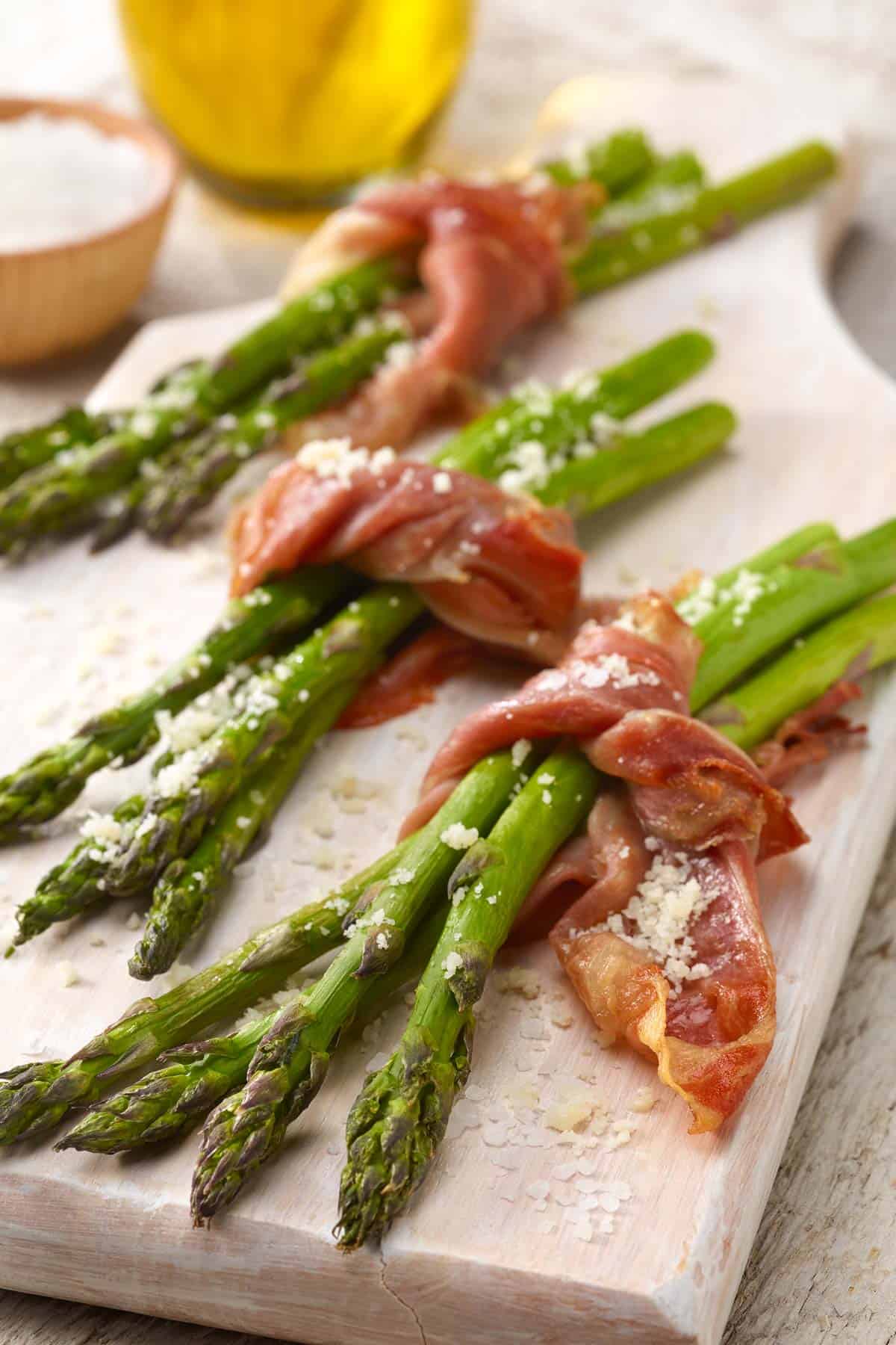 white board with bundles of Prosciutto Wrapped Asparagus