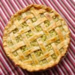 Rhubarb Pie on top of a red striped dish towel, showing detail of the woven lattice top.