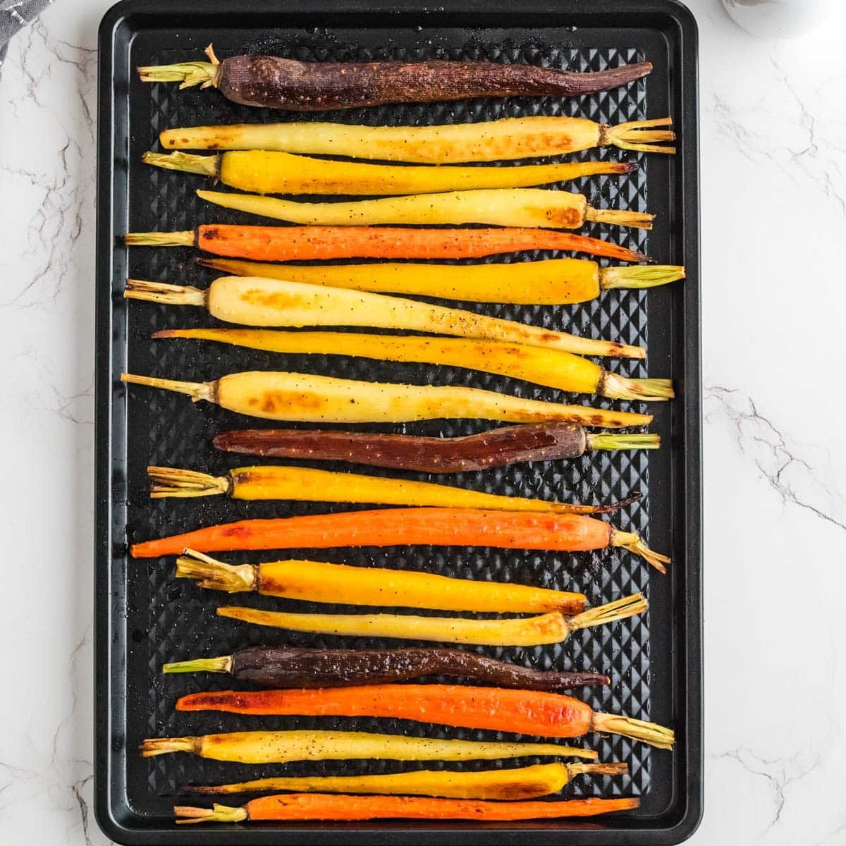 Roasted carrots on a baking tray.