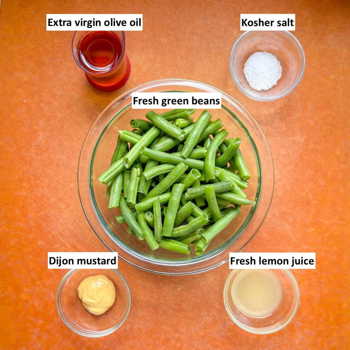 Ingredients for roasted green beans on a cutting board.