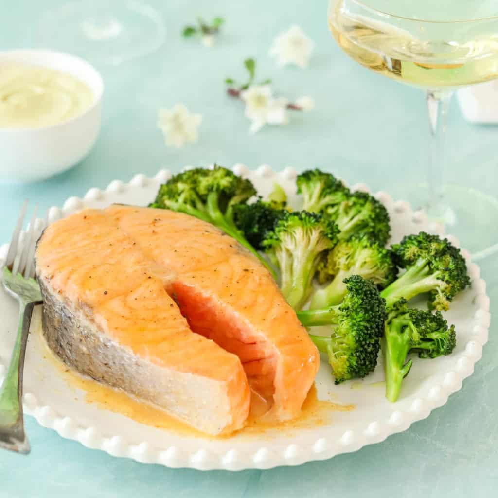 plate holding one Roasted Salmon Steak, with broccoli on the side