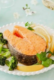 plate holding one Roasted Salmon Steak, with broccoli on the side