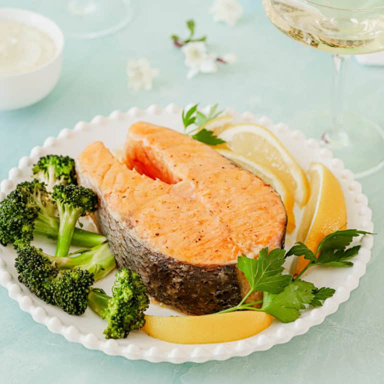 plate holding one Roasted Salmon Steak, with broccoli on the side