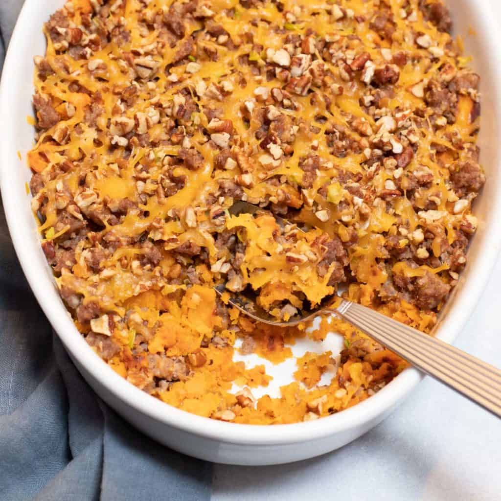 Sausage, Butternut Squash and Yam Casserole in a white baking dish