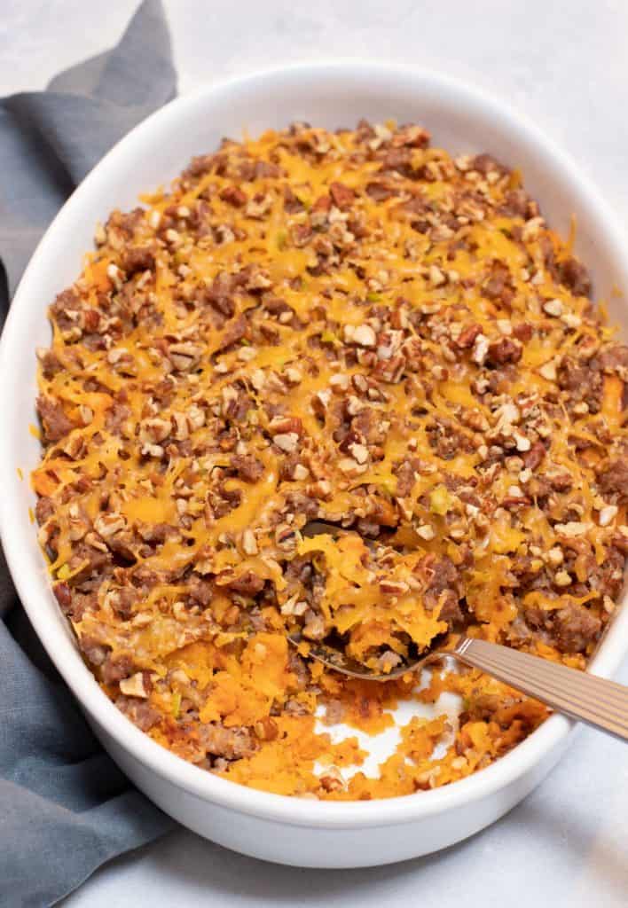 white baking dish filled with Sausage, Butternut Squash and Yam Casserole