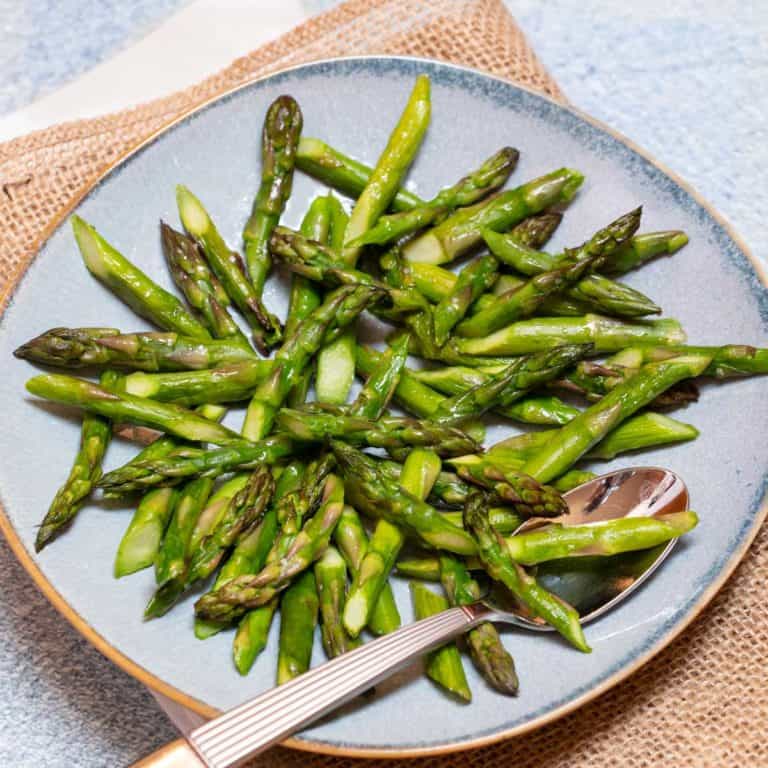 Blue plate filled with Quick and Easy Sauteed Asparagus