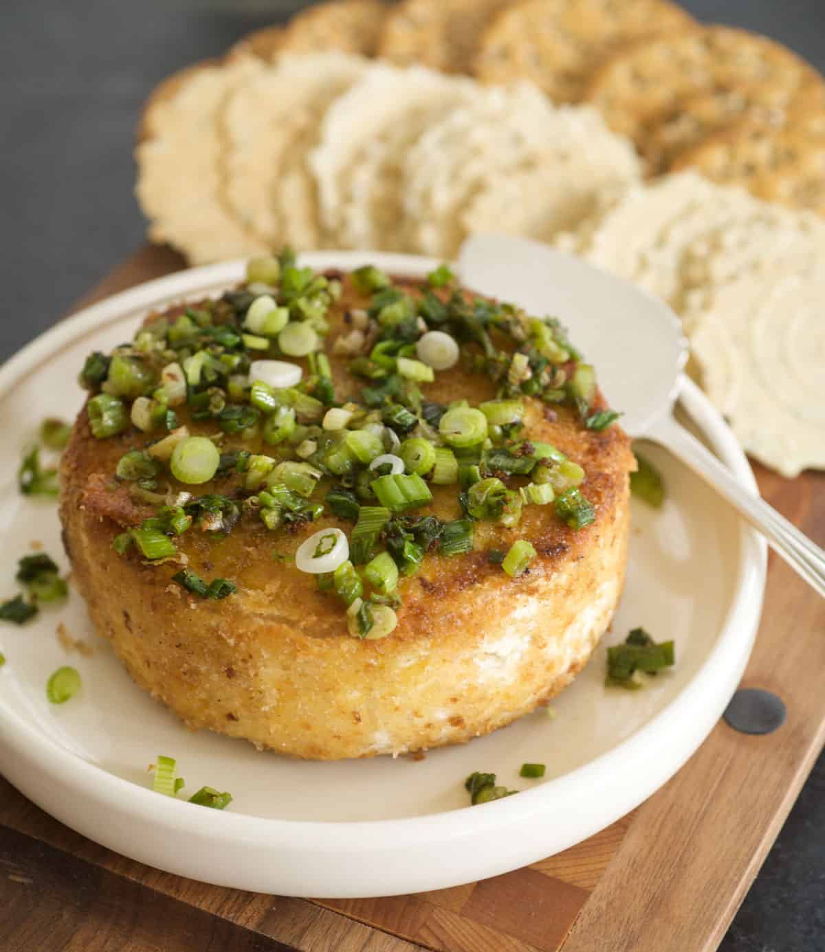 small wheel of brie, breaded and sauteed with chopped green onion on top