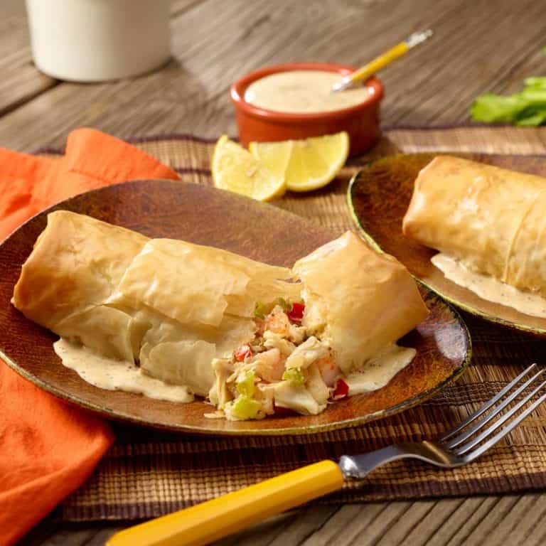 Brown plate with a Seafood Phyllo Bundle broken in half